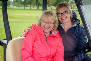 It’s a bad hair day on the links but Margy and Shelley are still smiling at the great turnout!